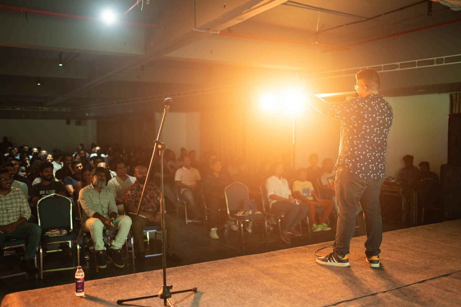 Stand-up comedian performing live for a packed audience at a Comedy Lounge comedy show Stand-up comedian performing for a live audience at a Comedy Lounge comedy event in Kerala.