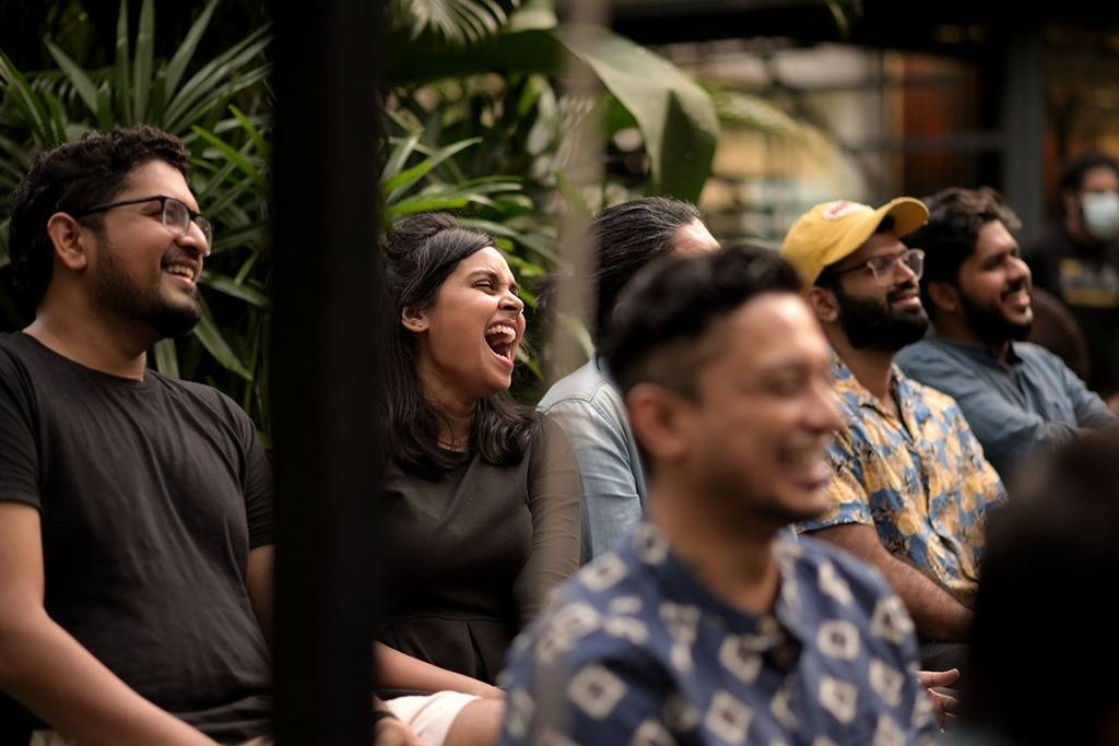 Audience members laughing during a live stand-up comedy show in Kochi Audience enjoying a live Comedy Lounge stand-up comedy performance in Kochi, Kerala.