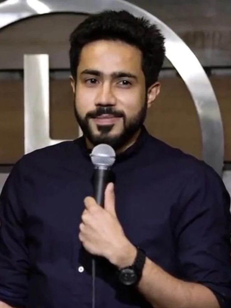 Indian stand-up comedian Abhishek Upmanyu performing on stage with a microphone