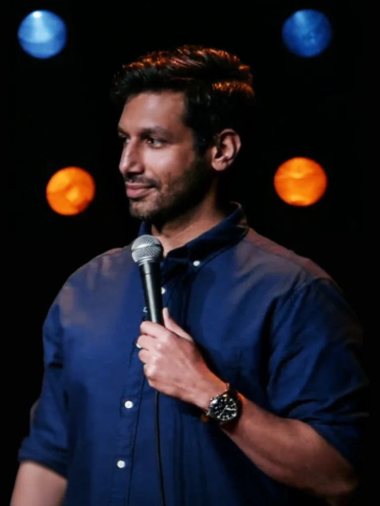 Kanan Gill performing live stand-up comedy under stage lights