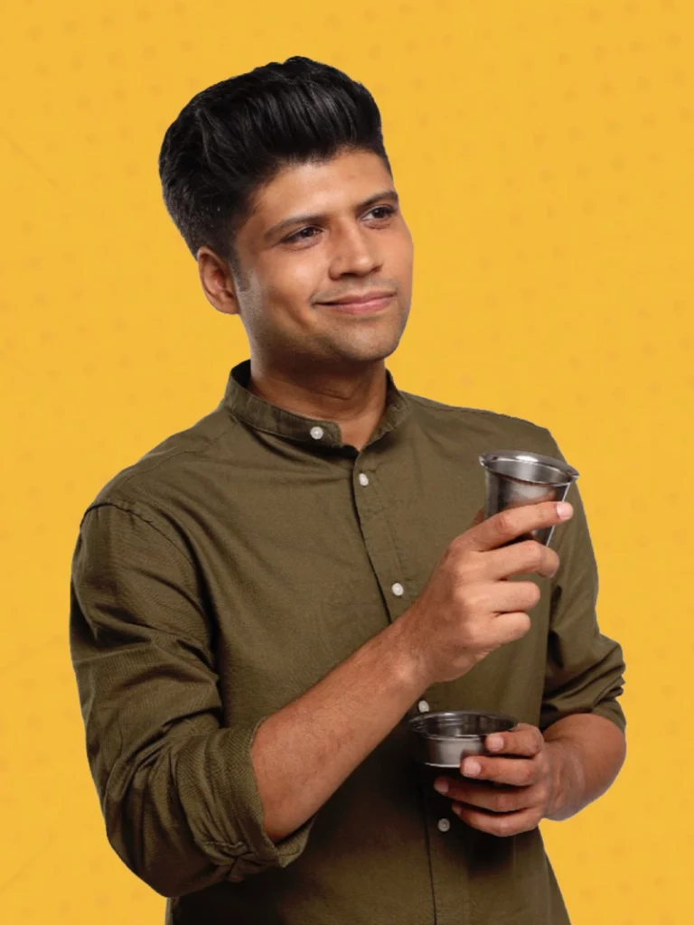 Rahul Subramanian stand-up comedian portrait with steel tumblers