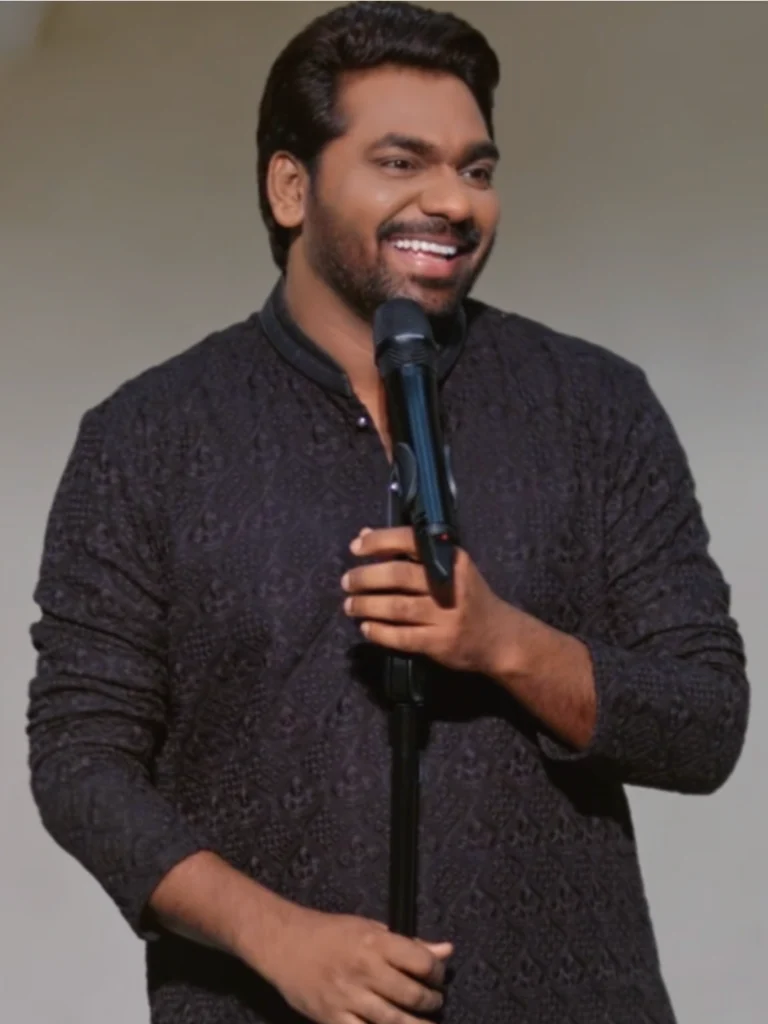 Zakir Khan performing stand-up comedy in traditional kurta