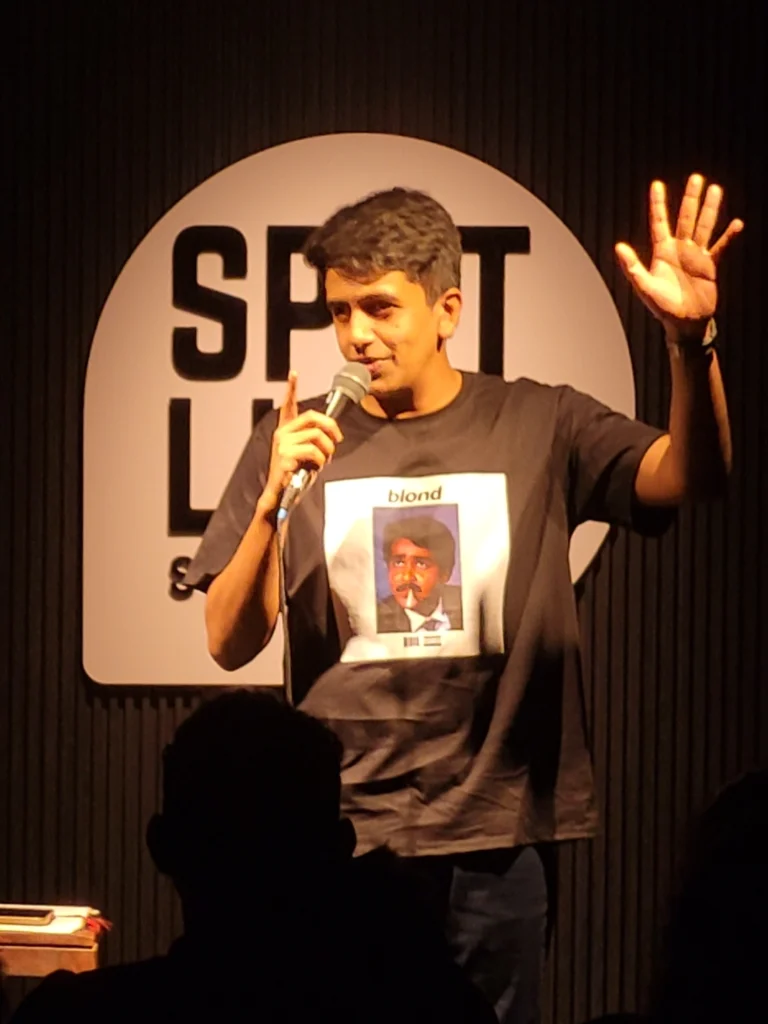 Gautham Govindan performing during a comedy tour stop at Spotlight Socials in Kochi.