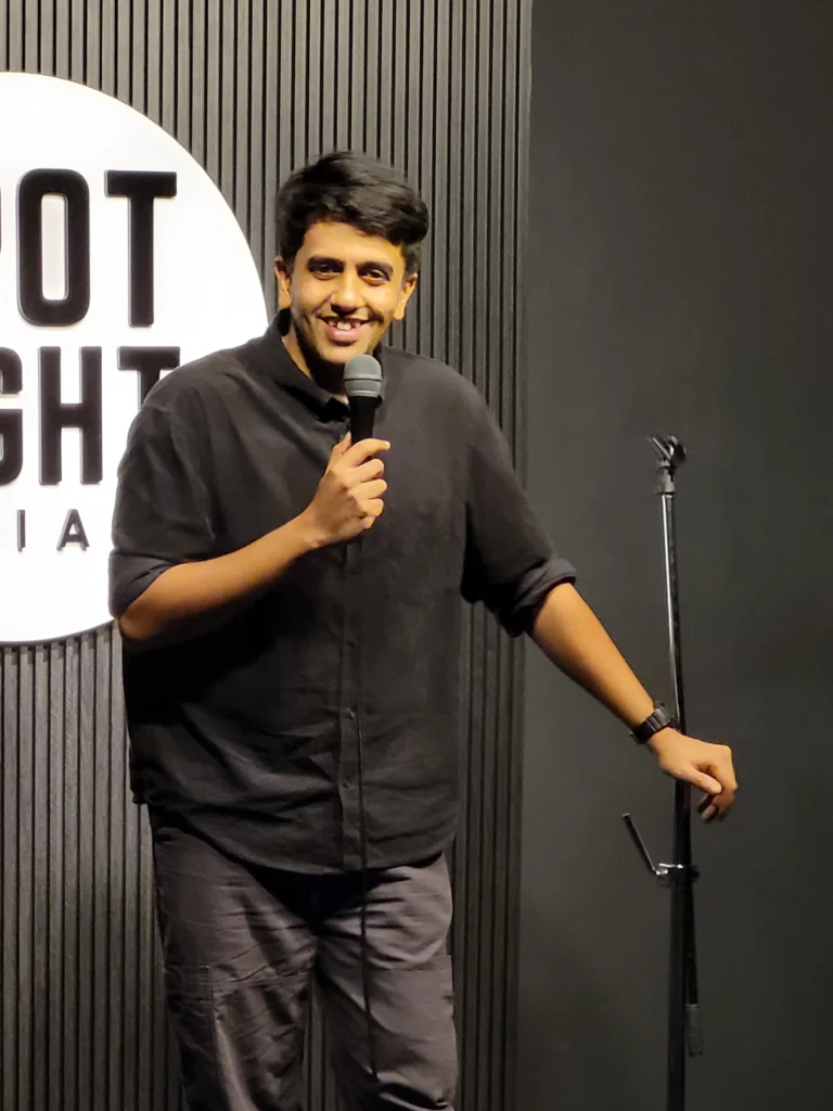 Gautham Govindan performing at Spotlight Socials during a Comedy Lounge stand-up comedy show in Kochi.
