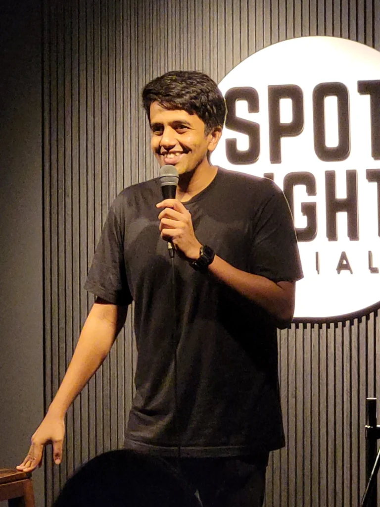 Gautham Govindan performing stand-up comedy at Spotlight Socials in Kochi.