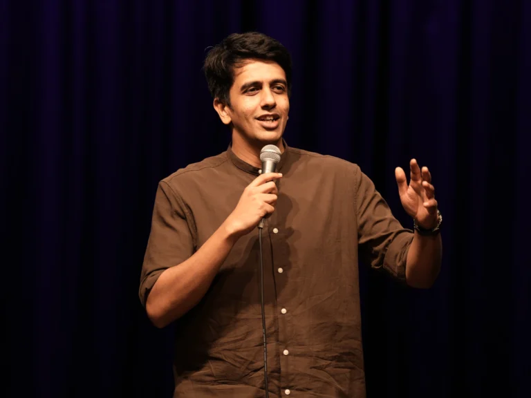Stand-up comedian Gautham Govindan performing live on stage.