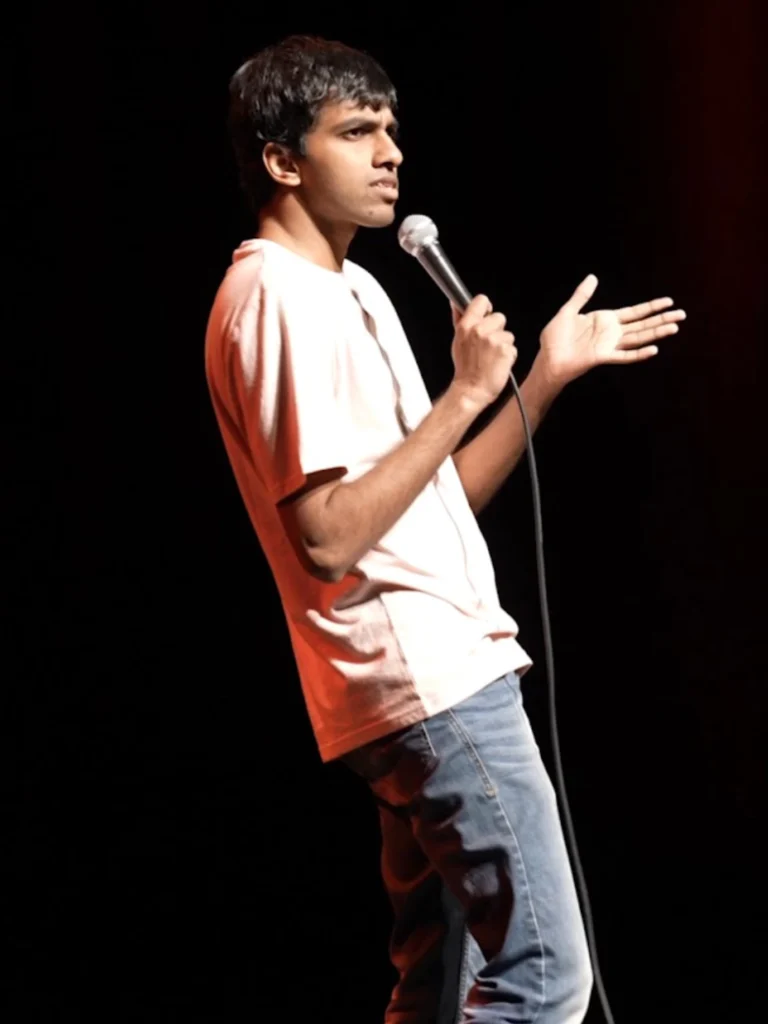 Tarang Hardikar performing stand-up comedy on stage.